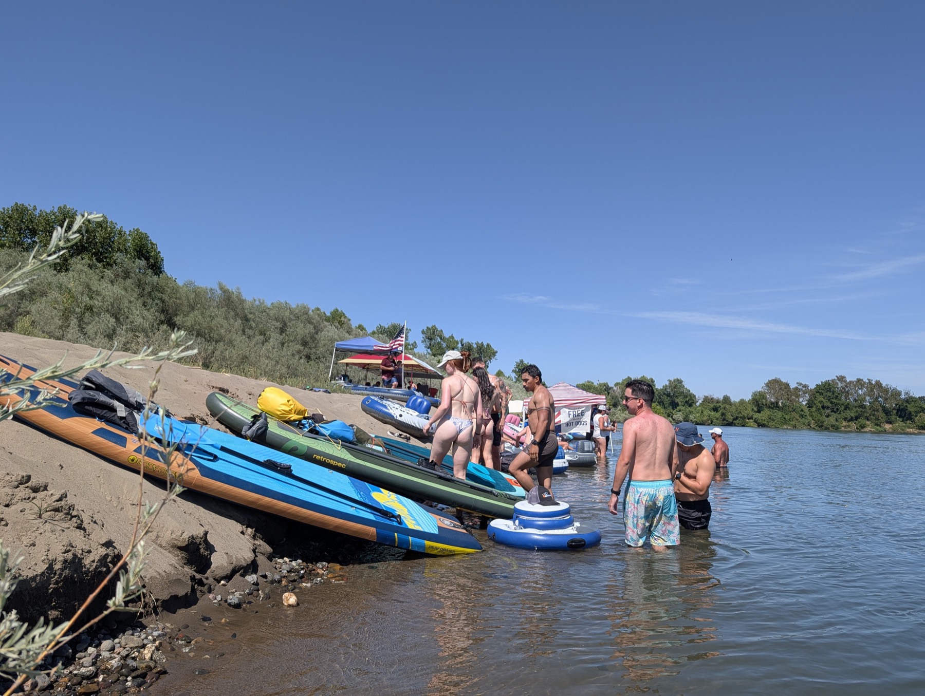 Paddleboards and floaters arriving at Beer Can Beach